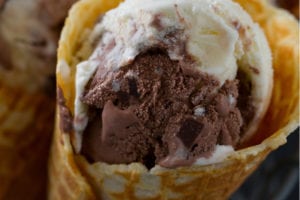 A mix of chocolate and vanilla ice cream in a waffle cone.