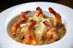 shrimp and grits in white bowl