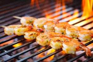 Skewered shrimp on a grill.