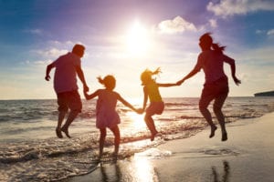 happy family jumping on beach